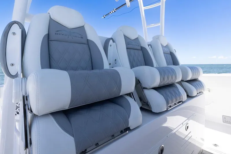  Yacht Photos Pics Luxury seating on 2023 Invincible 37 Catamaran, featuring sleek design and ocean backdrop.