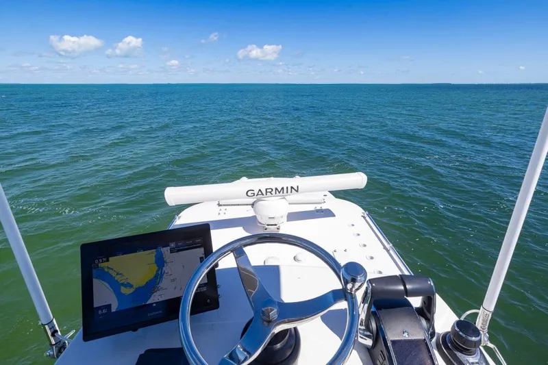  Yacht Photos Pics 2023 Invincible 37 Catamaran helm with Garmin navigation, open sea view.