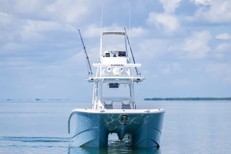  Yacht Photos Pics 2023 Invincible 37 Catamaran on calm water, showcasing sleek design and advanced features.