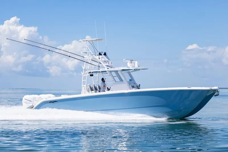  Yacht Photos Pics 2023 Invincible 37 Catamaran cruising on clear blue waters under a sunny sky.