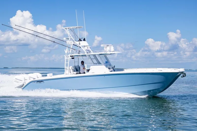  Yacht Photos Pics 2023 Invincible 37 Catamaran cruising on open water under a clear blue sky.