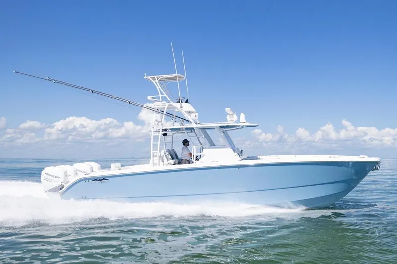  Yacht Photos Pics 2023 Invincible 37 Catamaran cruising on open water under clear blue skies.