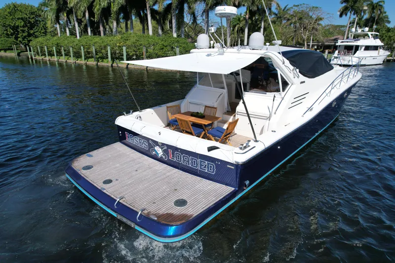  Yacht Photos Pics 1999 Uniesse 57 Open yacht cruising on a scenic waterway.