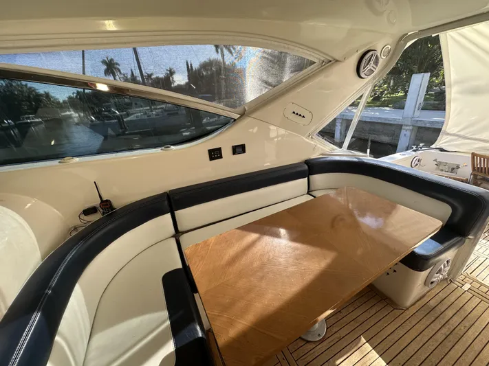  Yacht Photos Pics Luxurious interior of 1999 Uniesse 57 Open yacht with elegant seating and wooden table.