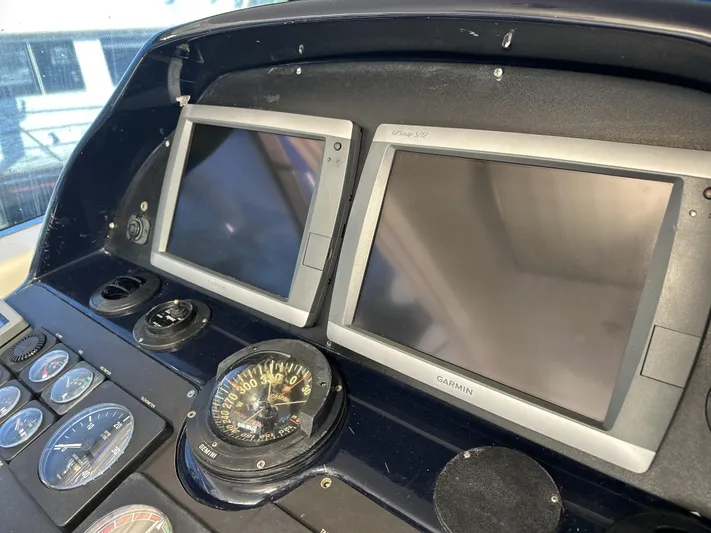  Yacht Photos Pics Control panel of 1999 Uniesse 57 Open yacht with navigation screens and compass.
