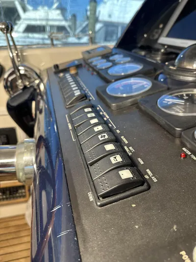  Yacht Photos Pics Control panel of a 1999 Uniesse 57 Open yacht, featuring switches and gauges.