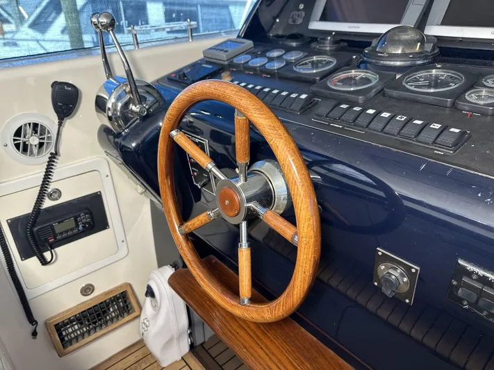  Yacht Photos Pics Control panel of a 1999 Uniesse 57 Open yacht with wooden steering wheel.