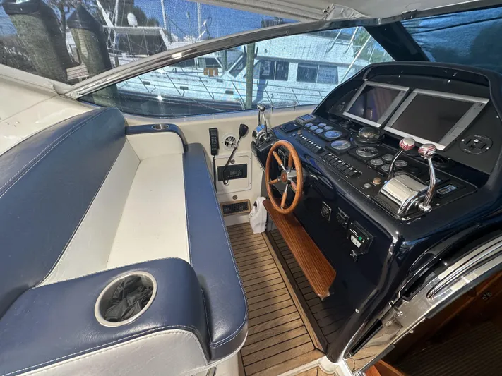  Yacht Photos Pics Cockpit of 1999 Uniesse 57 Open yacht with steering wheel and navigation controls.