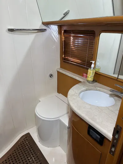  Yacht Photos Pics Bathroom interior of 1999 Uniesse 57 Open yacht, featuring sink and toilet.