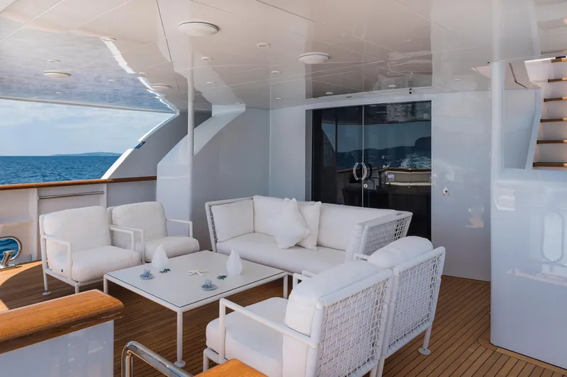 Claudia Berruto Yacht Photos Pics Luxurious deck seating on 2001 Baglietto M/Y 32 D yacht with ocean view.