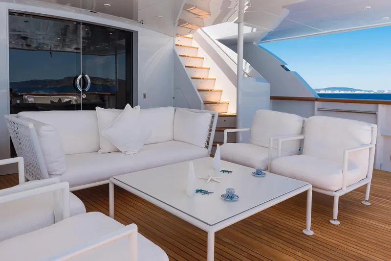 Claudia Berruto Yacht Photos Pics Luxurious deck seating on 2001 Baglietto M/Y 32 D yacht with ocean view.