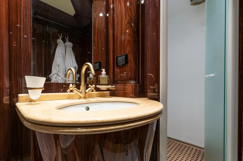 Claudia Berruto Yacht Photos Pics Luxurious bathroom on 2001 Baglietto M/Y 32 D yacht with elegant wood and marble finishes.