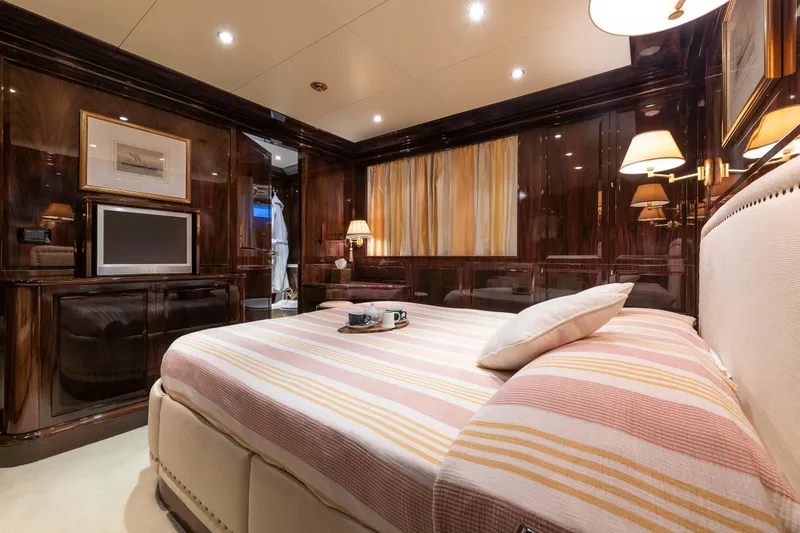 Claudia Berruto Yacht Photos Pics Luxurious bedroom interior on Baglietto M/Y 32 D yacht, 2001 model, with elegant wood finishes.