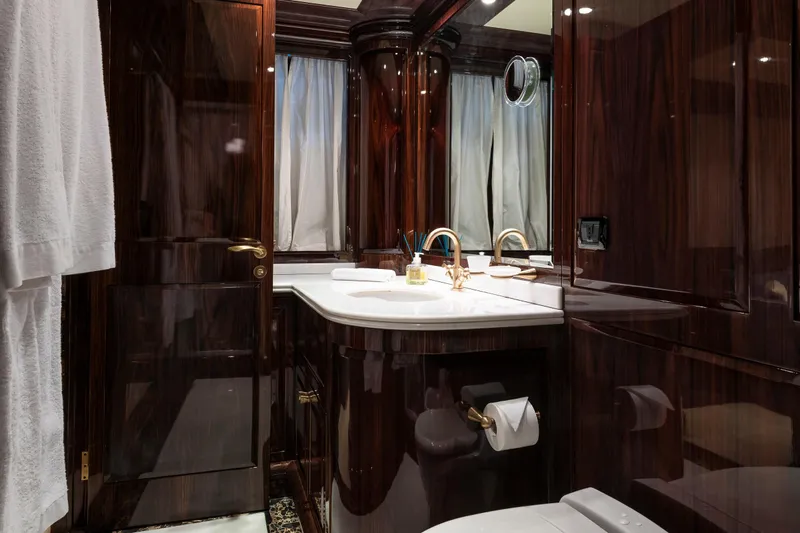 Claudia Berruto Yacht Photos Pics Luxurious bathroom interior on Baglietto M/Y 32 D yacht, featuring elegant wood finishes, 2001 model.