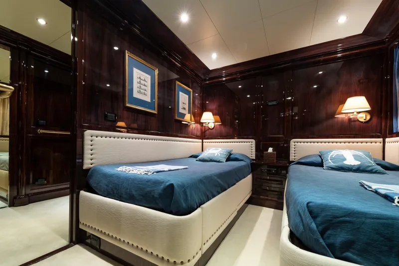 Claudia Berruto Yacht Photos Pics Luxurious twin bedroom on 2001 Baglietto M/Y 32 D yacht with elegant wood paneling.
