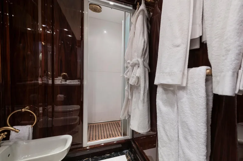 Claudia Berruto Yacht Photos Pics Luxurious yacht bathroom with elegant wood paneling and plush white robes, Baglietto M/Y 32 D, 2001.
