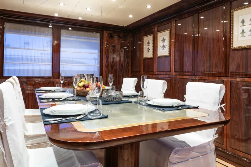 Claudia Berruto Yacht Photos Pics Luxurious dining area on 2001 Baglietto M/Y 32 D yacht with elegant wood paneling.