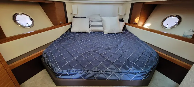 Lori L Yacht Photos Pics Luxurious 2018 Tiara Yachts 39 cabin with elegant bedding and porthole windows.