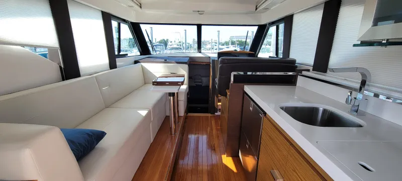 Lori L Yacht Photos Pics Luxurious interior of 2018 Tiara Yachts 39 with modern seating and kitchen area.