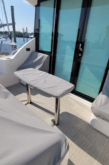 Lori L Yacht Photos Pics 2018 Tiara Yachts 39 cockpit with covered seating and table, docked at marina.