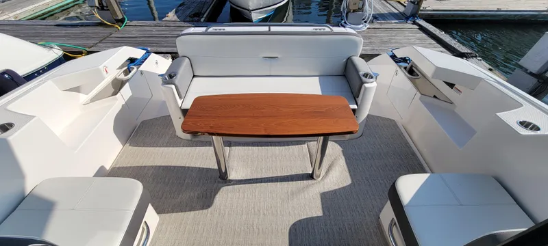 Lori L Yacht Photos Pics Spacious seating area on 2018 Tiara Yachts 39 with wooden table and cushioned seats.