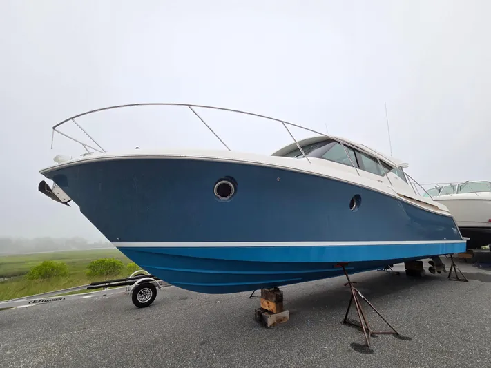 Lori L Yacht Photos Pics 2018 Tiara Yachts 39 boat on stands, blue hull, overcast sky.