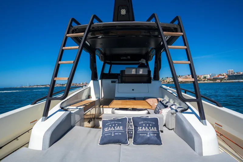  Yacht Photos Pics 2019 Bluegame BG42 yacht deck with cushions, ladder, and ocean view.
