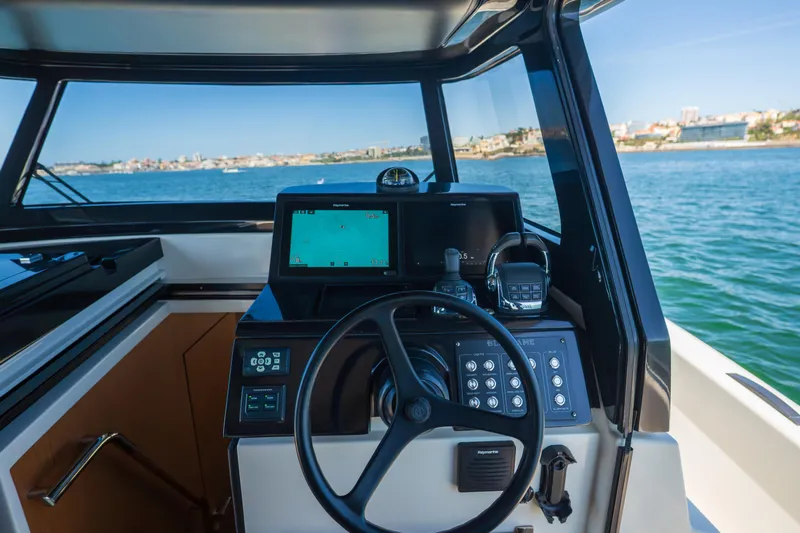  Yacht Photos Pics 2019 Bluegame BG42 yacht helm with navigation equipment, steering wheel, and sea view.