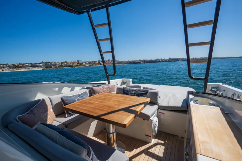  Yacht Photos Pics Luxurious 2019 Bluegame BG42 yacht deck with seating, table, and ocean view.