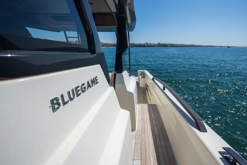  Yacht Photos Pics 2019 Bluegame BG42 yacht on serene blue waters, showcasing sleek design and craftsmanship.