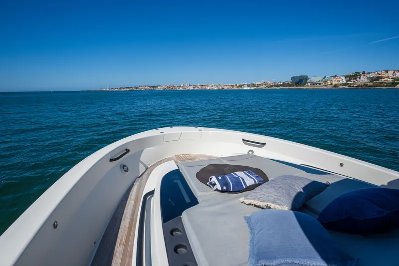  Yacht Photos Pics 2019 Bluegame BG42 yacht with cushions, cruising on a sunny day near the coastline.