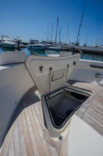  Yacht Photos Pics 2019 Bluegame BG42 yacht with open storage compartment, docked at marina.