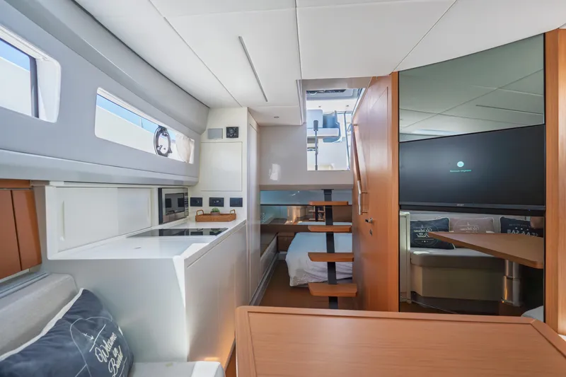  Yacht Photos Pics Interior of 2019 Bluegame BG42 yacht featuring modern kitchen and cozy sleeping area.
