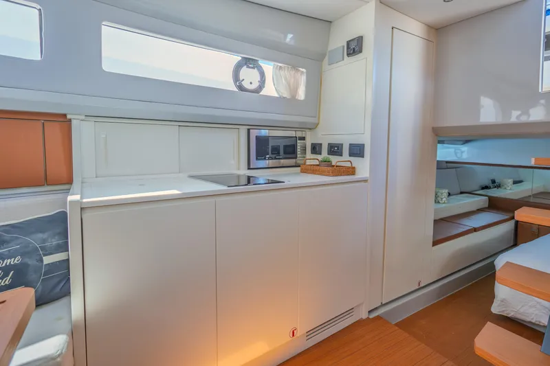  Yacht Photos Pics Interior of 2019 Bluegame BG42 yacht with modern kitchen and cozy sleeping area.