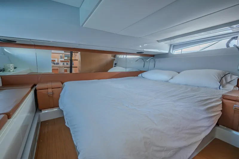  Yacht Photos Pics Luxurious cabin interior of 2019 Bluegame BG42 yacht with comfortable bedding.