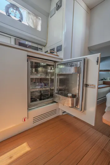 Yacht Photos Pics Open refrigerator inside 2019 Bluegame BG42 yacht, showcasing modern interior design.