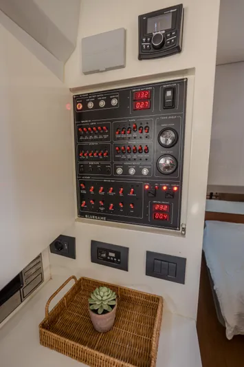  Yacht Photos Pics Control panel inside 2019 Bluegame BG42 yacht, featuring switches and displays, with a decorative basket.