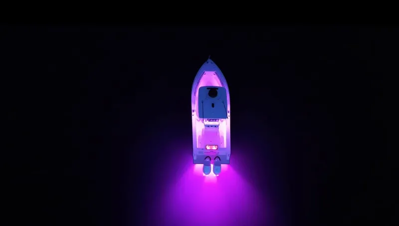  Yacht Photos Pics Aerial view of 2025 Reef Runner 280 boat with vibrant purple lights on water.