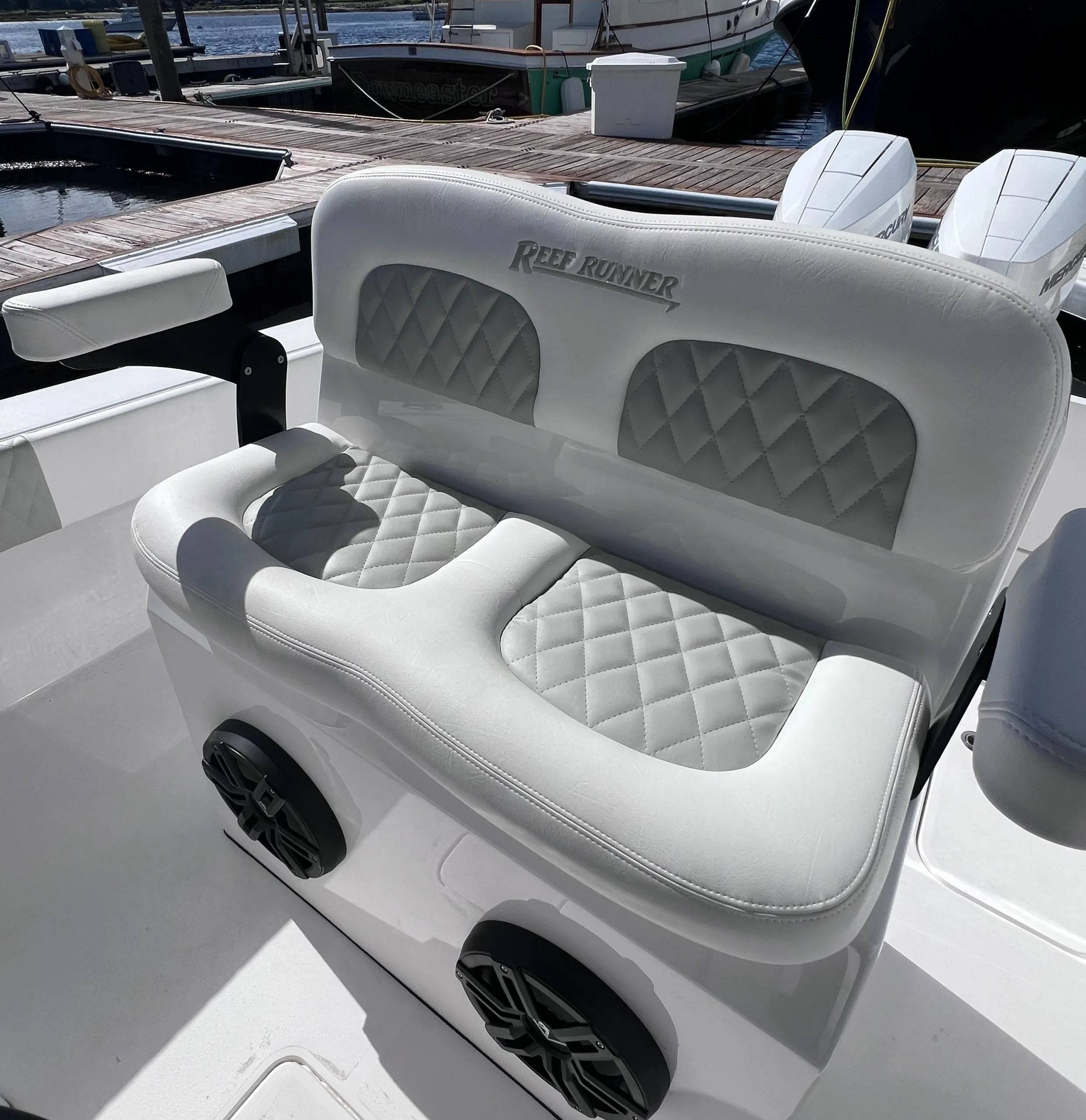 2025 Reef Runner 280 boat with luxurious white seating and quilted design at marina.