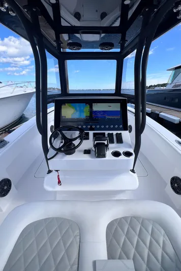  Yacht Photos Pics 2025 Reef Runner 280 boat cockpit with modern navigation system and dual seats.