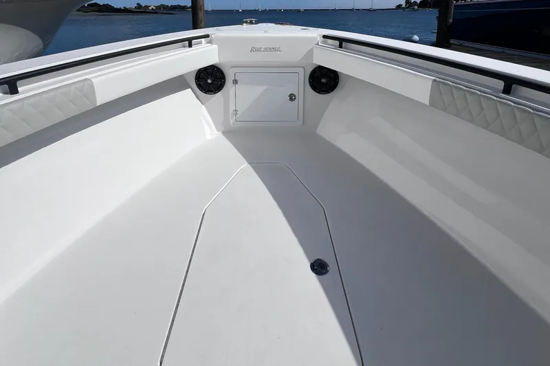  Yacht Photos Pics 2025 Reef Runner 280 boat interior with spacious white deck and storage compartment.
