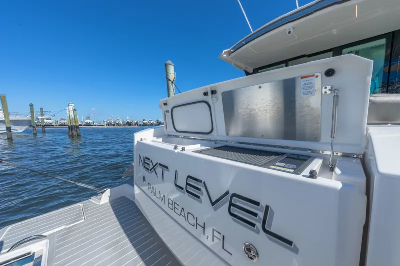 Next Level Yacht Photos Pics 2025 Tiara Yachts 43 LE at dock, Palm Beach, FL, under clear blue sky.