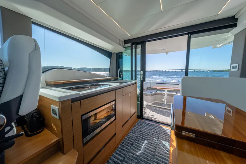 Next Level Yacht Photos Pics Luxurious interior of 2025 Tiara Yachts 43 LE with modern kitchen and ocean view.