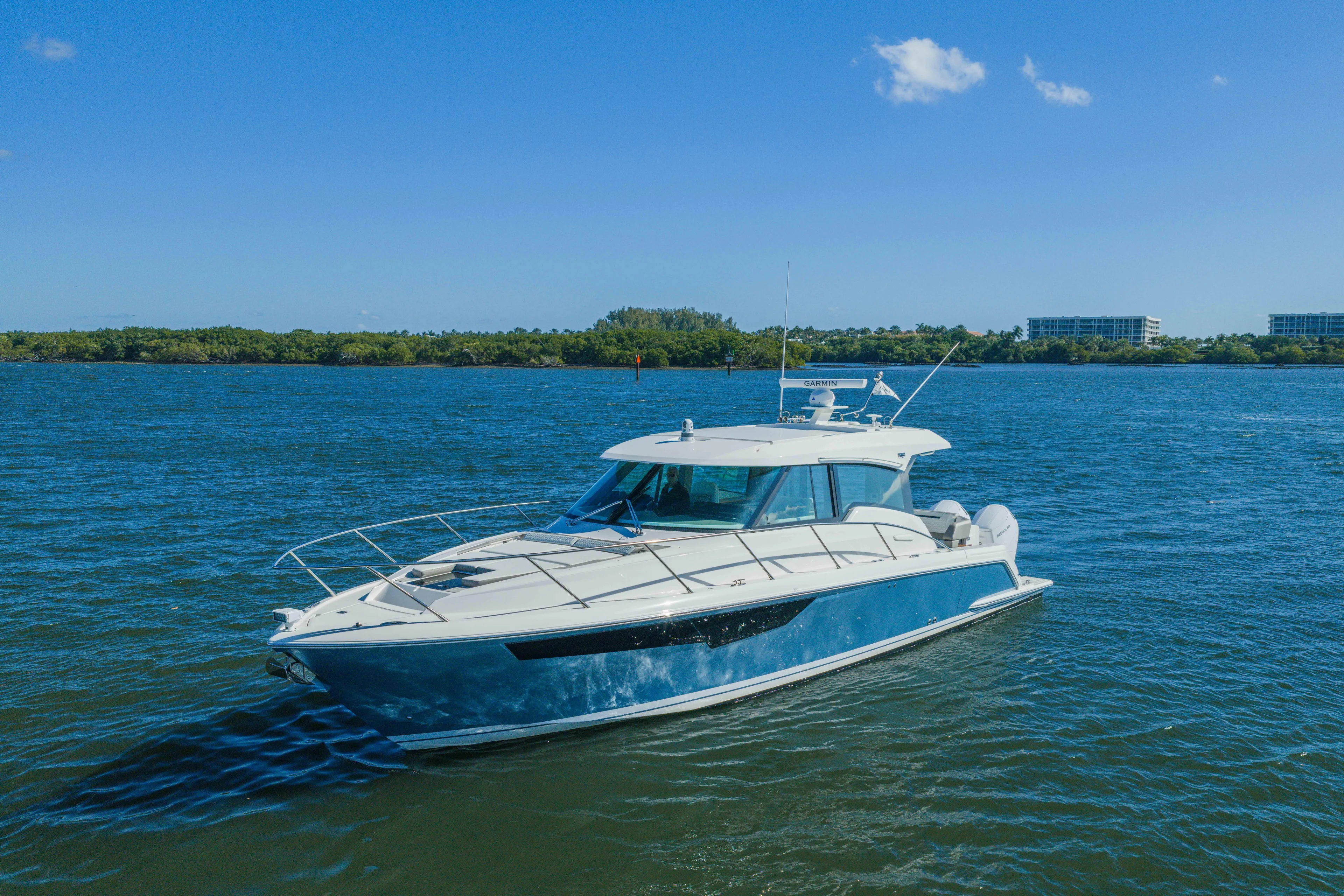 Next Level Yacht Photos Pics 2025 Tiara Yachts 43 LE cruising on a sunny day in open water.