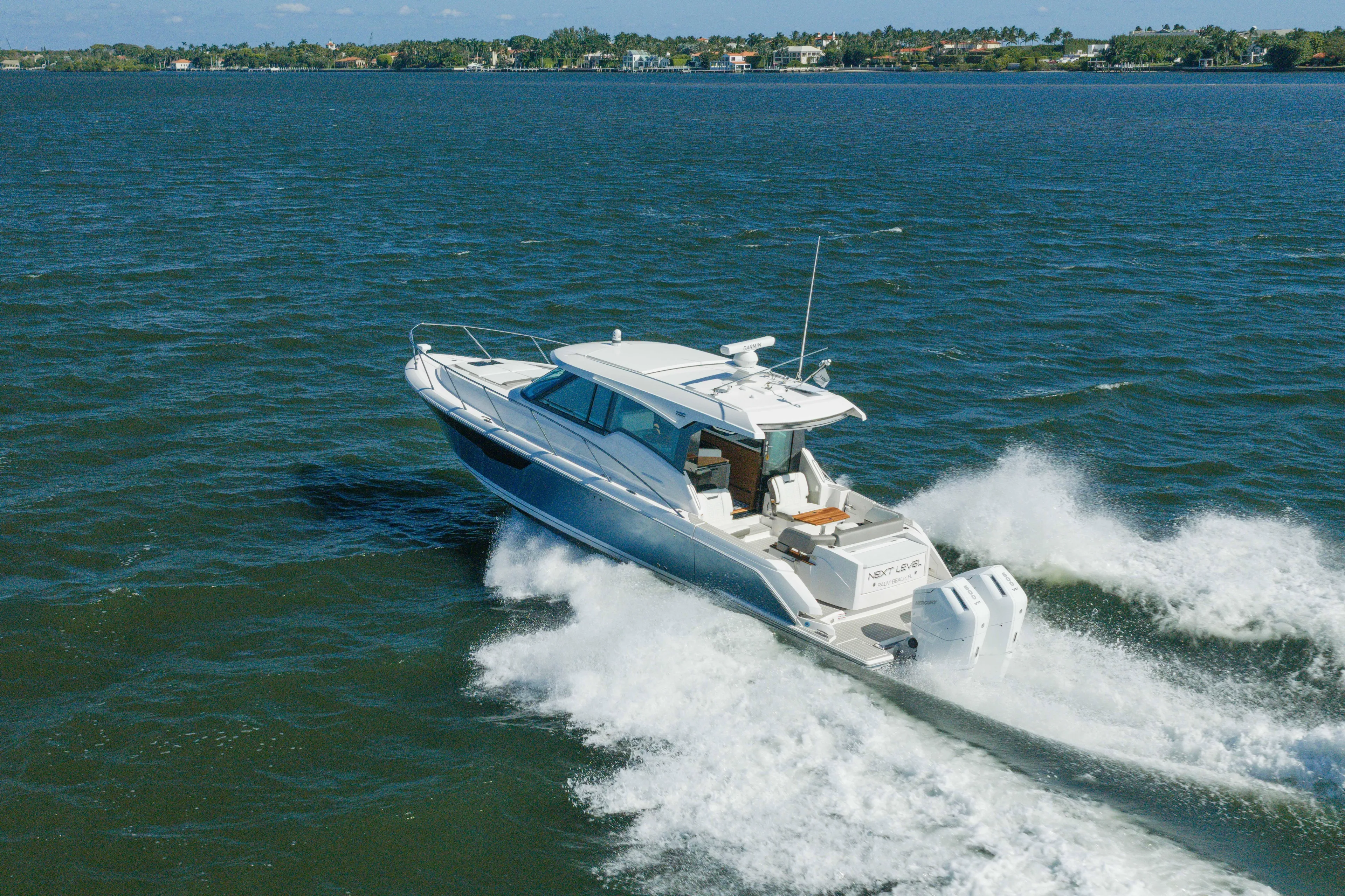 Next Level Yacht Photos Pics 2025 Tiara Yachts 43 LE cruising on open water, showcasing sleek design and powerful performance.