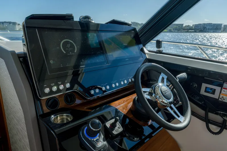Next Level Yacht Photos Pics Helm of 2025 Tiara Yachts 43 LE with advanced navigation system and steering wheel.