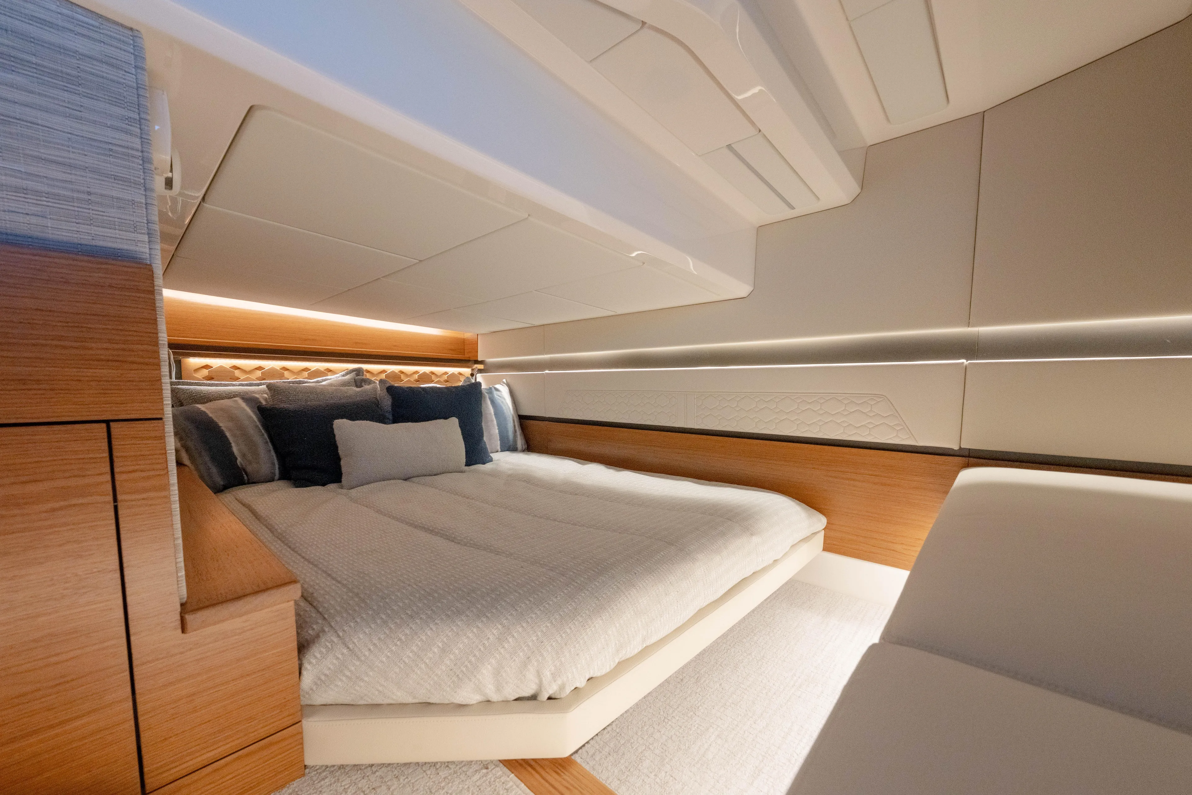 Next Level Yacht Photos Pics Luxurious interior cabin of 2025 Tiara Yachts 43 LE, featuring elegant bedding and modern design.