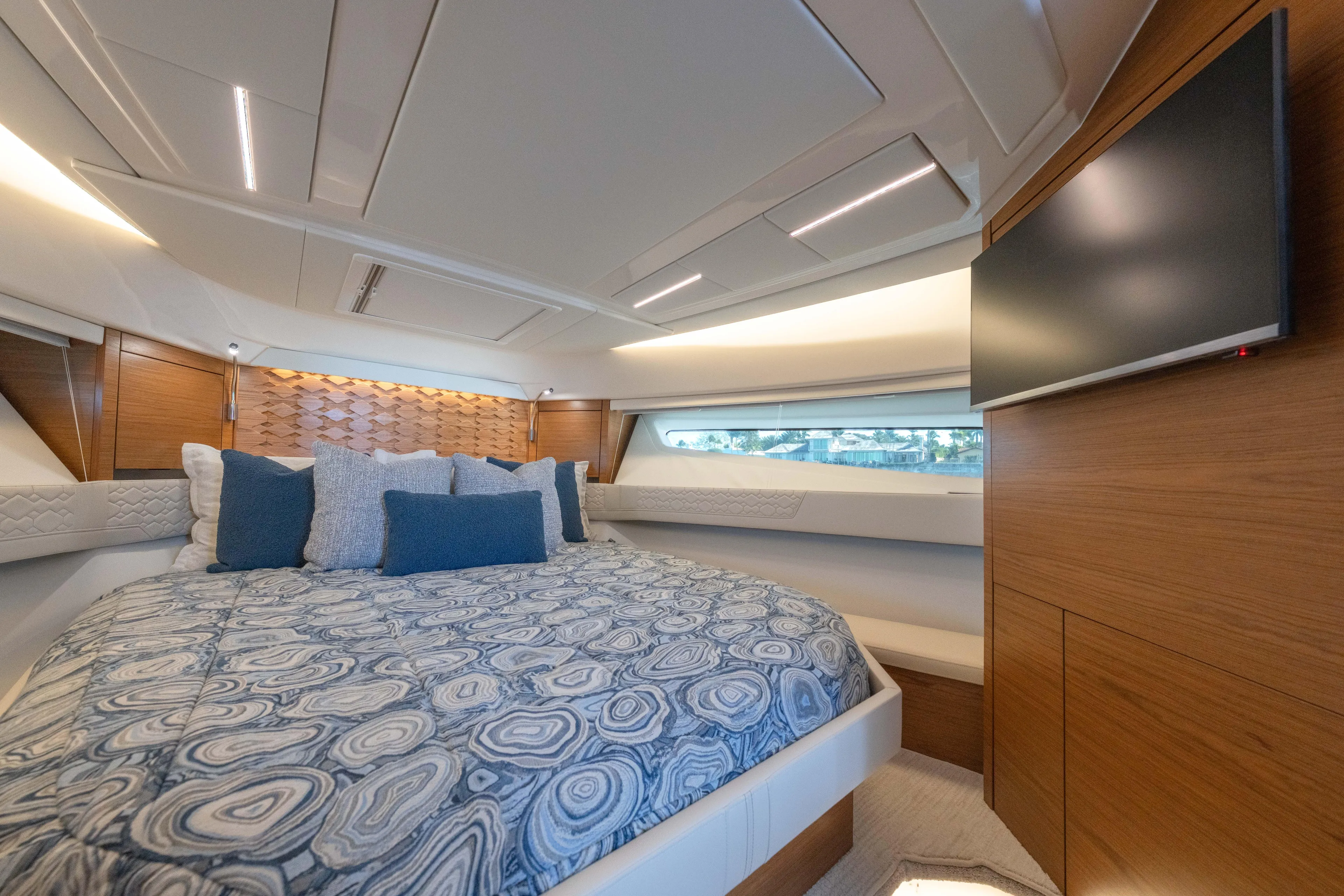 Next Level Yacht Photos Pics Luxurious 2025 Tiara Yachts 43 LE bedroom with modern design and elegant bedding.