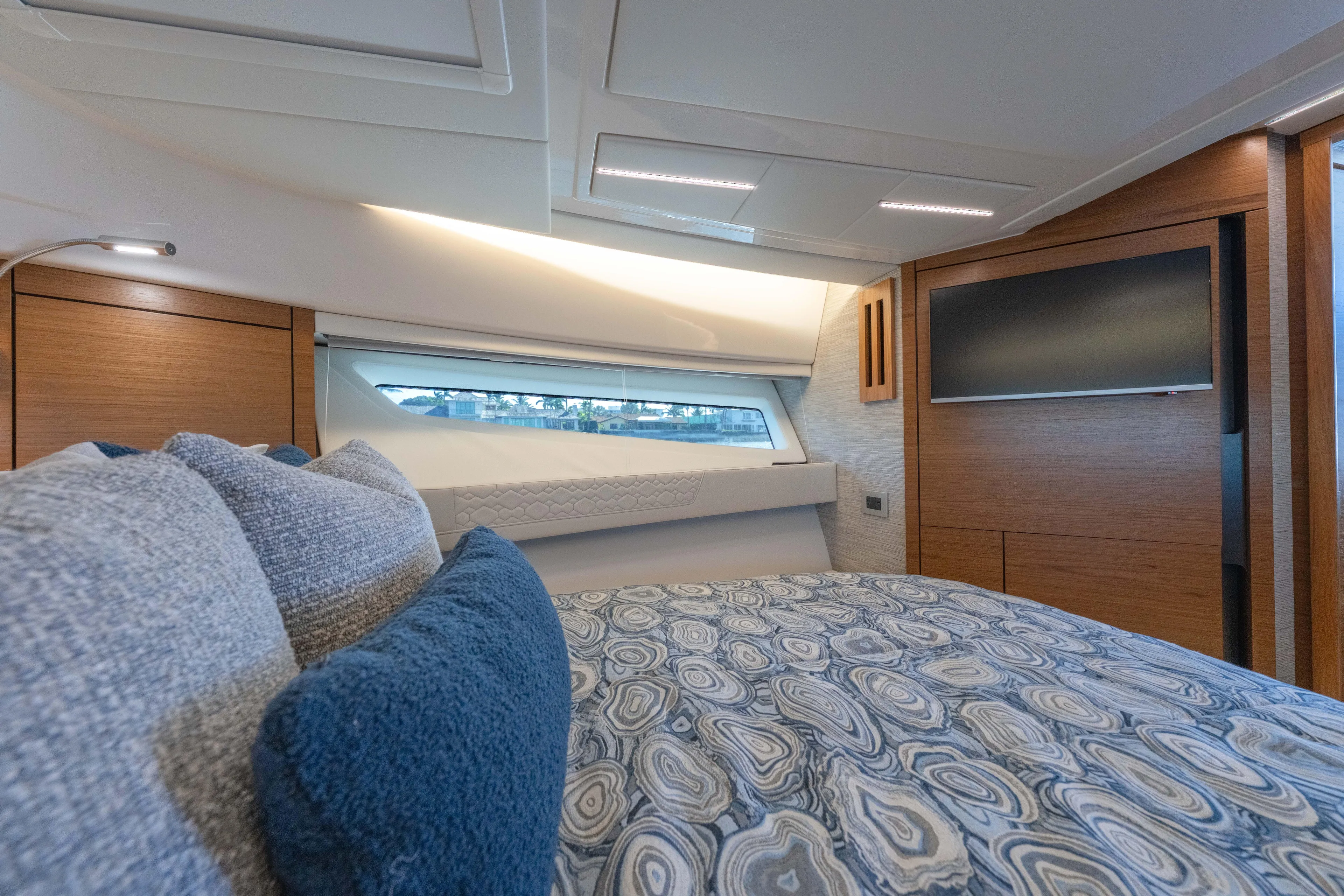Next Level Yacht Photos Pics Luxurious interior of 2025 Tiara Yachts 43 LE, featuring elegant bedding and modern design.