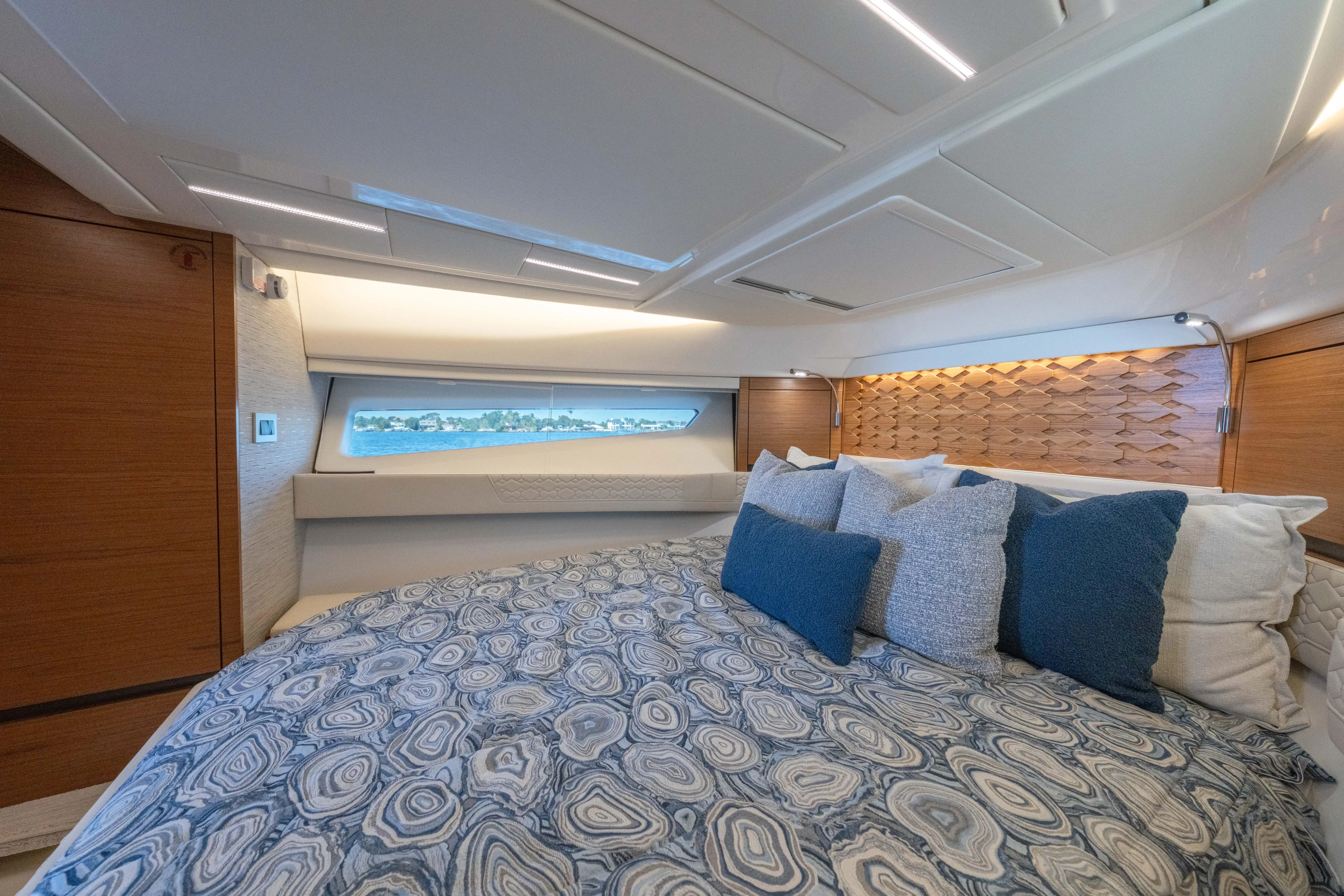Next Level Yacht Photos Pics Luxurious 2025 Tiara Yachts 43 LE cabin interior with elegant bedding and modern design.